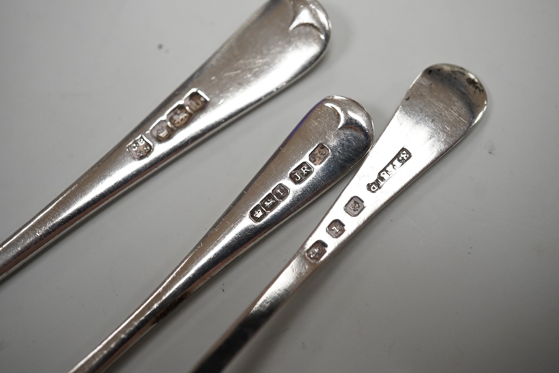 An ornate Edwardian silver oval mustard pot and matching spoon by Barker Brothers, Birmingham, 1902, length, 95mm, together with five other assorted silver condiments including a pair of pierced oval salts with blue glas